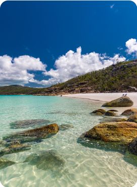 Rocks on Whitehaven Beach with white sand in the Whitsunday Islands, Queensland, Australia.