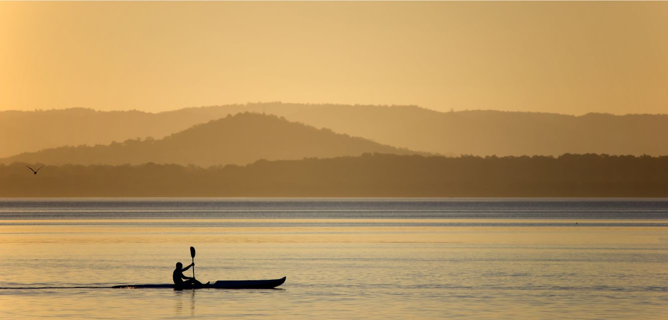 Sunset kayaking on Tuggerah Lake, New South Wales.