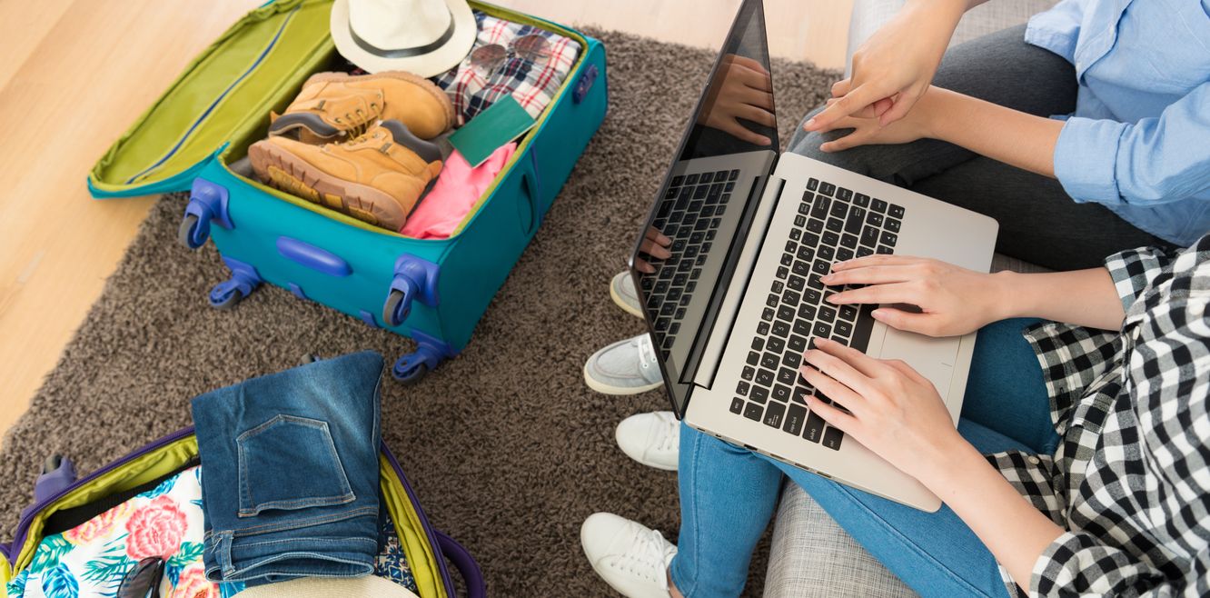 Couple booking their rental car holiday on a laptop.