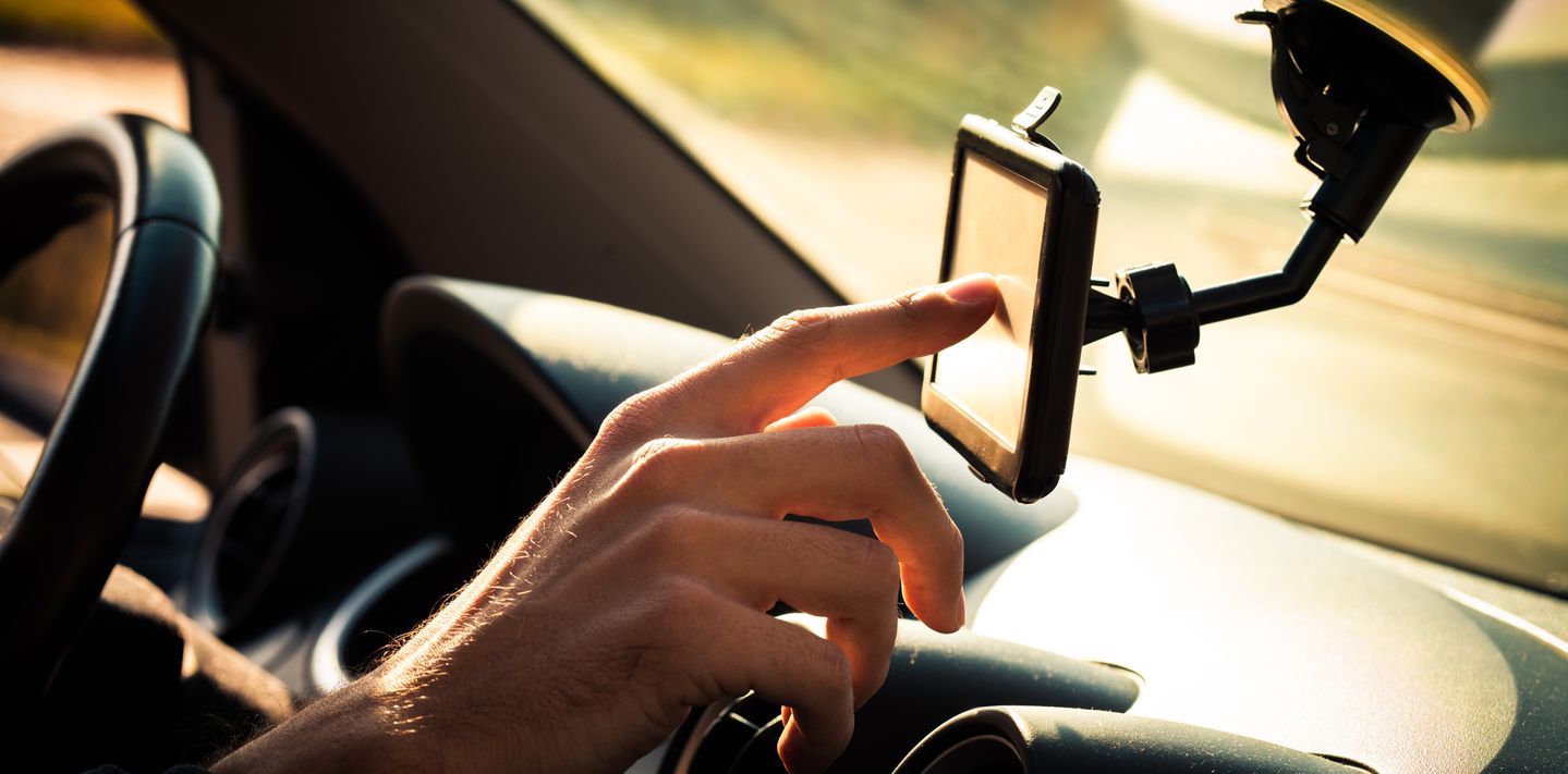 Driver using a GPS in a rental car.