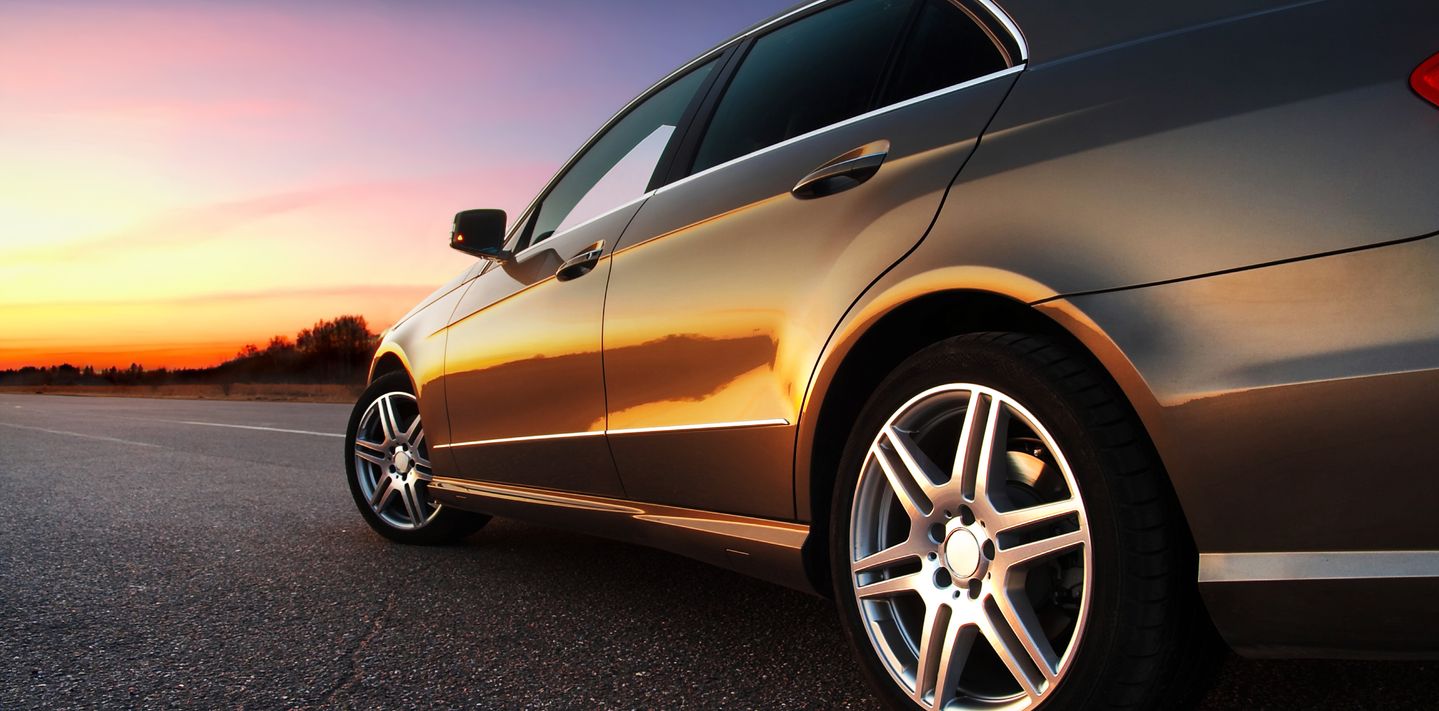 A luxury car at sunset.