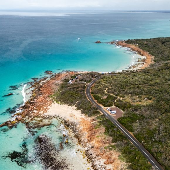 Cars and a campervan at a parking lot overlooking the sea in the south of Western Australia.