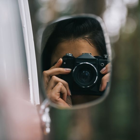 Taking a photo in the rear view mirror.