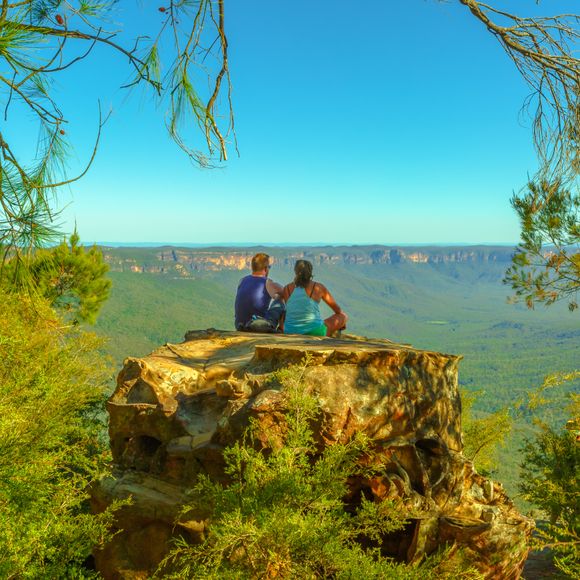 Two hikers enjoy an outlook at the Blue Mountains.